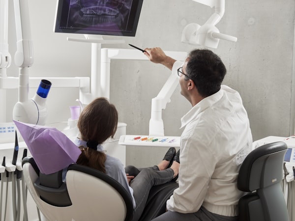 Smile Quest dentist discussing treatment with a patient